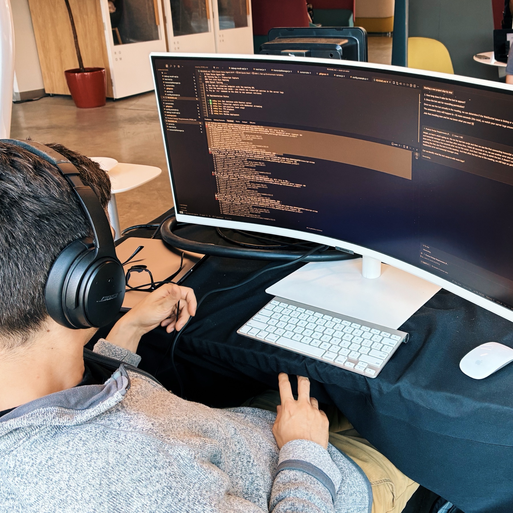 Developers collaborating in a room with laptops